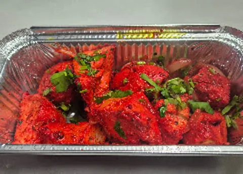 Tandoori chicken in a foil tray